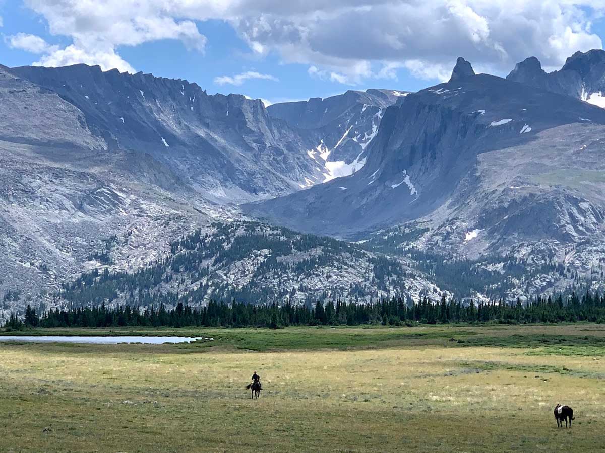 Photo of horse and rider in front of Bighorn Mountains